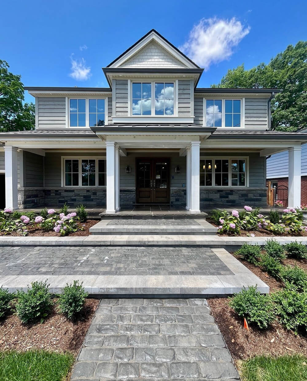 Front entrance hardscape and softscape designed and installed by Outscape Group in Burlington