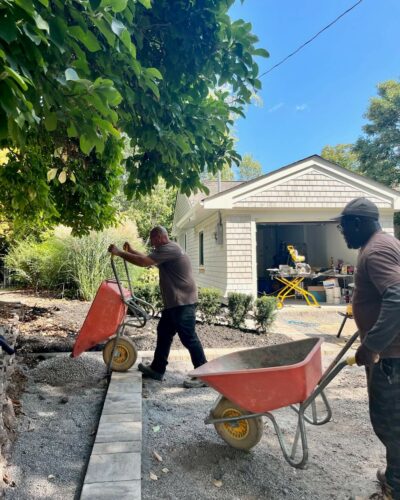 Men working on interlocking driveway